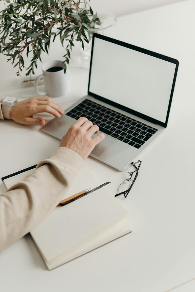 pexels photo 4065864 4065864 A clean and modern workspace featuring a laptop, houseplant, and notebook.